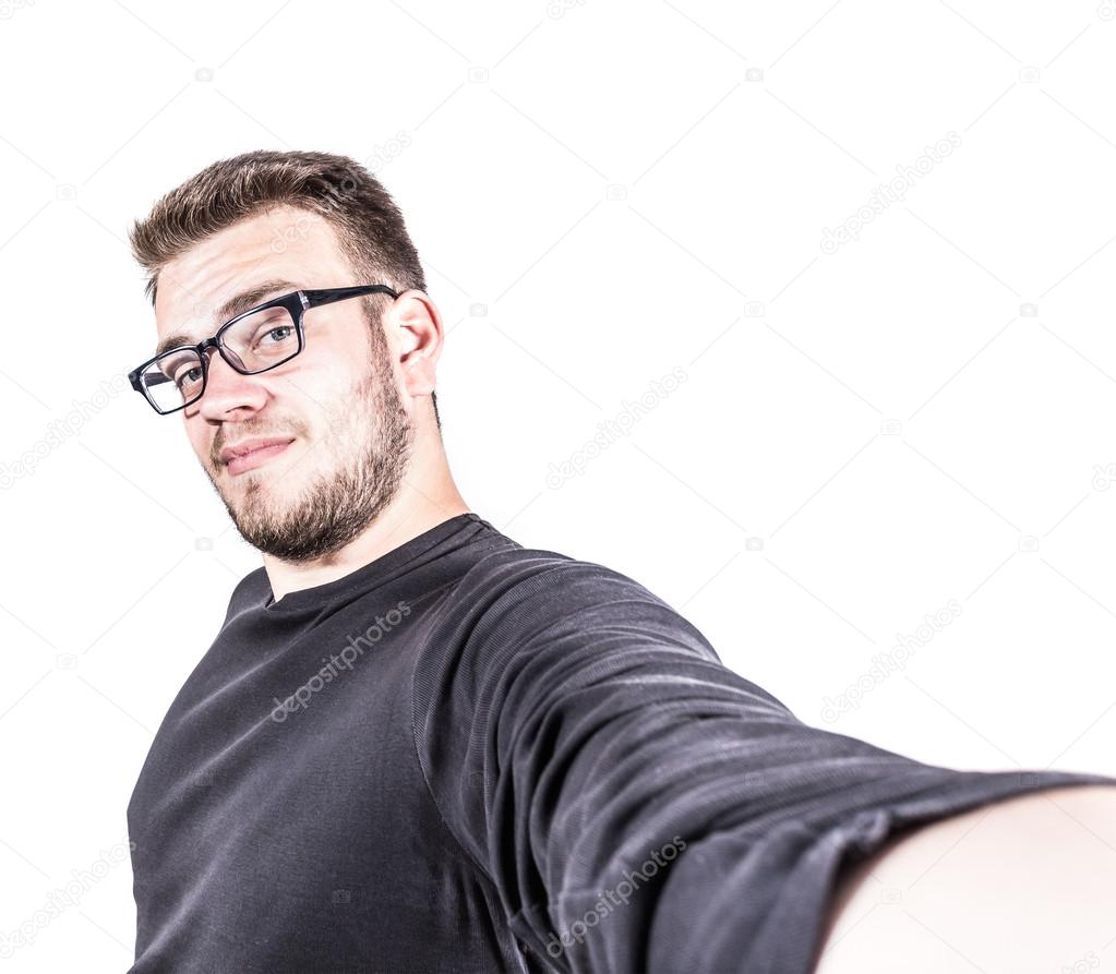 Happy young man taking a selfie photo. Isolated on white background.
