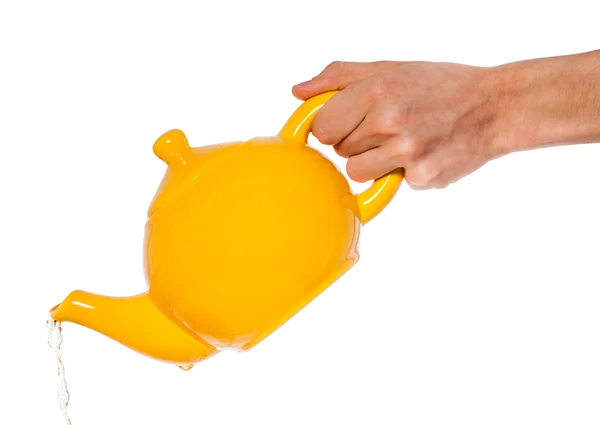 Yellow teapot in hand isolated on white background — Stock Photo, Image