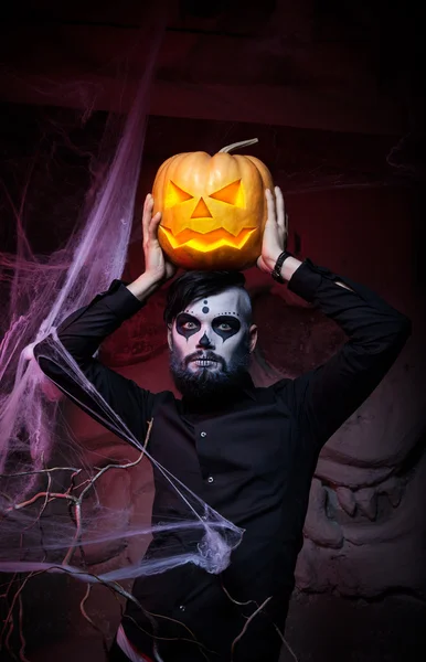 Halloween concept with young man in day of the dead mask face art. — Stock Photo, Image