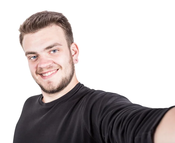 Joven feliz tomando una foto de selfie. Aislado sobre fondo blanco — Foto de Stock