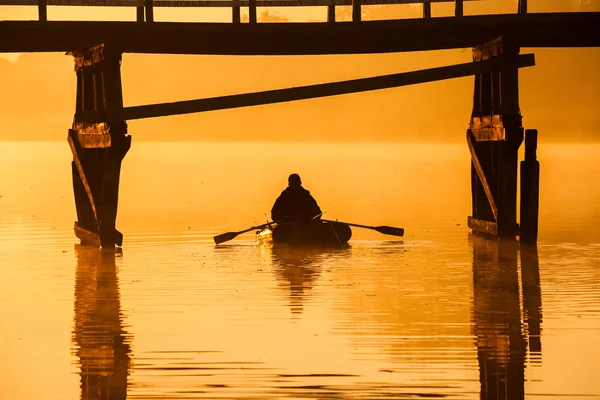 Beautiful sunset by the river. Fisherman is in the boat — Stock Photo, Image