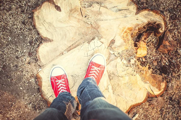 Young man feet in red sneakers — Stock Photo, Image