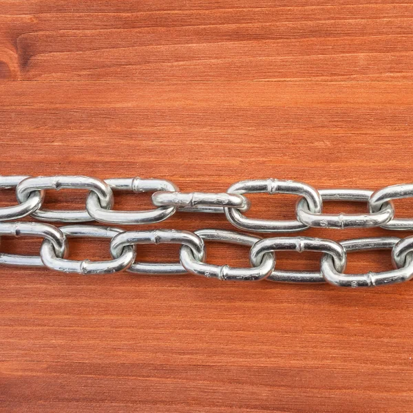 Metal chain links on wooden background — Stockfoto