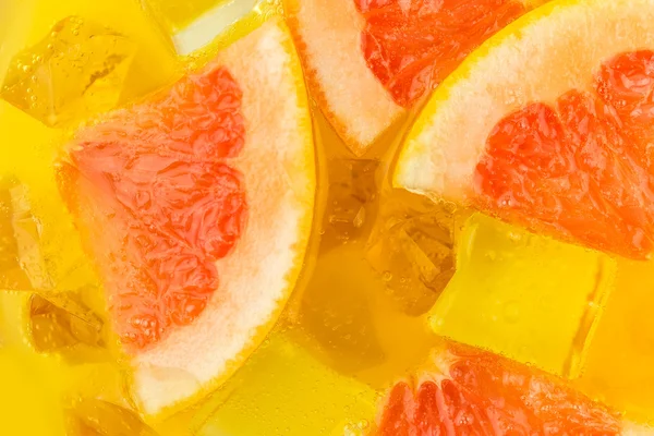 Primer plano de cubitos de hielo en zumo de naranja y pomelo — Foto de Stock