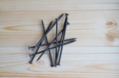 Ahşap arka planda siyah vidaları bağlama fotoğrafı