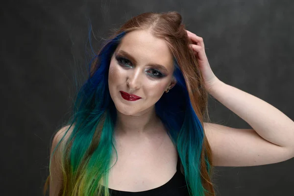 Model with perfect healthy dyed hair. Beauty fashion model girl with colorful dyed hair. Girl with perfect makeup and hairstyle.