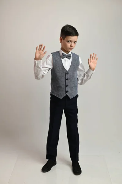 Foto de un adolescente en pleno crecimiento en un traje sobre un fondo blanco en diferentes poses — Foto de Stock