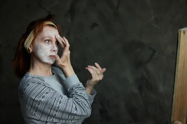 Portrait Caucasian Woman Applying Aging Cosmetics Her Face Front Mirror — Foto de Stock