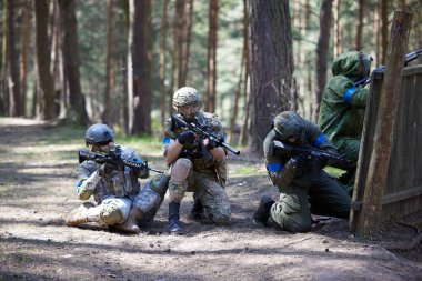 Minsk, Belarus, May 9, 2021 - Reporting of a real airsoft game in a forest with a backdrop of scenery. High resolution photos clipart