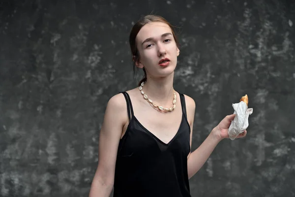 Mujer Tranquila Posando Con Hamburguesa Mano Sobre Fondo Gris Mirando —  Fotos de Stock