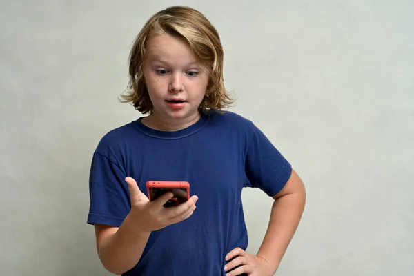 Young Caucasian Teenage Boy Long Hair Uses Phone Smile White — Stok fotoğraf