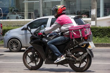 Chiangmai, Thailand -July 14 2021: Delivery service man ride a Motercycle of Food Panda. On road no.1001, 8 km from Chiangmai city.
