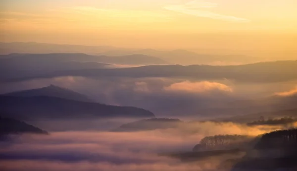 Sunset over hills with fog — Stock Photo, Image