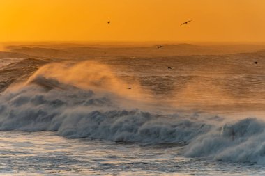 Reynisfjara Sahili 'ndeki Dyrholaey Burnu' ndan ve İzlanda 'daki Reynisdrangar bazalt deniz yığınlarından görüntüler. Fırtınalı gün doğumu