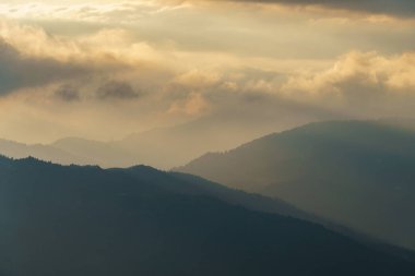 Gün batımında Avrupa Alpleri 'nde bir dağ sırasının manzarası. Sonbaharda yamaçlar