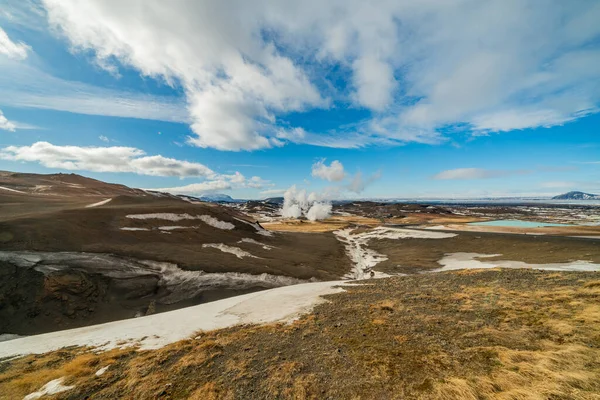 Namafjall Hverir geothermal area in Iceland. Stunning landscape of sulfur valley with smoking fumaroles and blue cloudy sky, travel background, tourist attraction — Stock Photo, Image