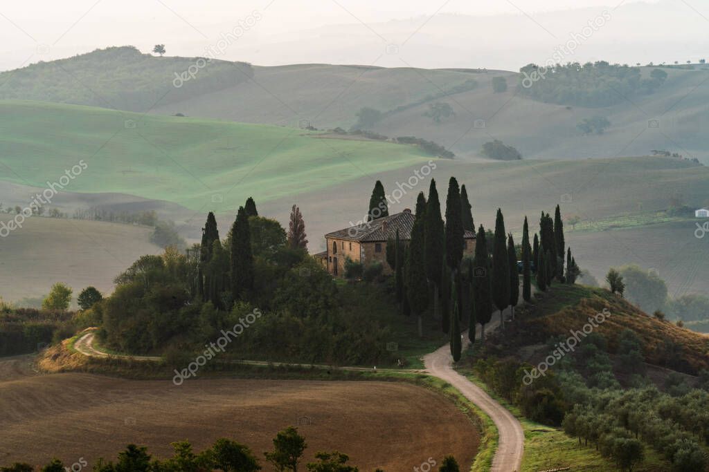 Fabulous Tuscan landscape with hills and valleys in golden morning light, Val dOrcia, Italy.