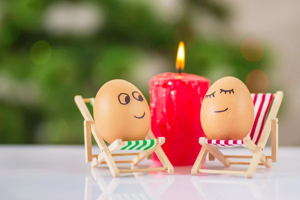 Funny eggs on a beach chair relaxing — Stock Photo, Image