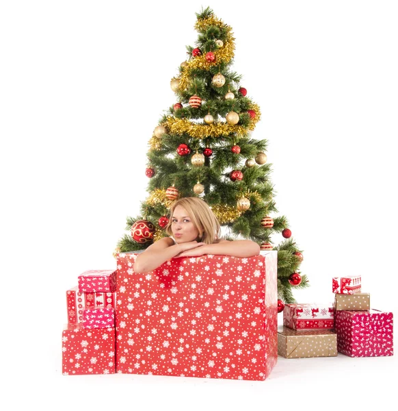 Woman inside of gift box and christmas tree behind — Stock Photo, Image