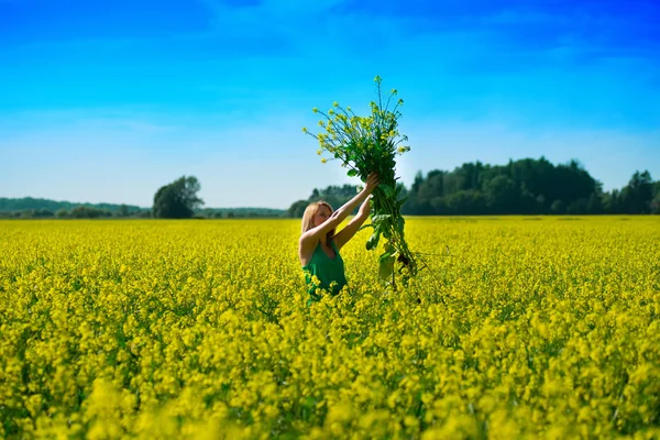 Blond woman in a rape field — Stock Photo, Image