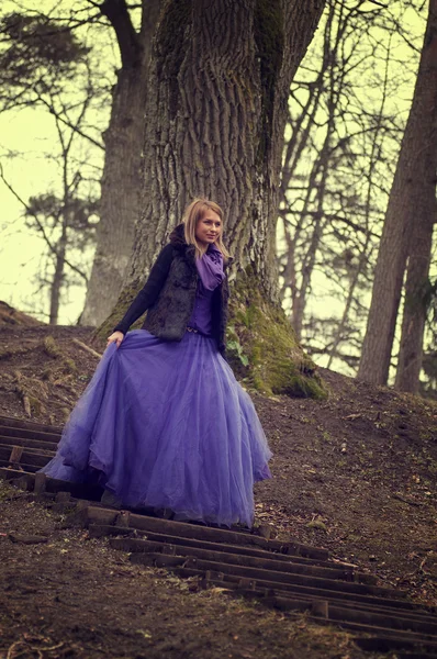 Frau im Wald mit violettem Kleid — Stockfoto