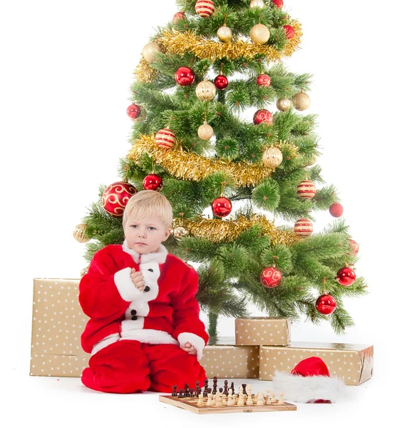 Child dressed as a gnome play chess — Stock Photo, Image