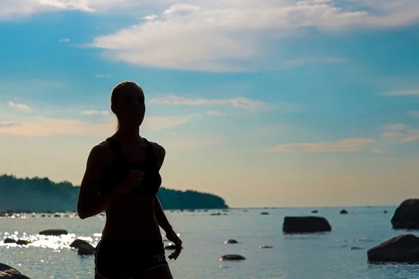 Running woman silhouette on beach. — Stock Photo, Image