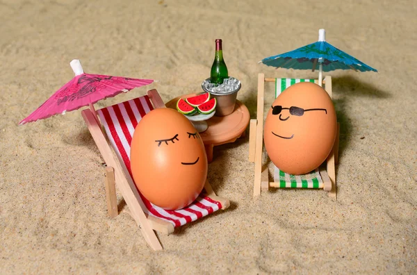 Easter funny eggs under umbrella Royalty Free Stock Images