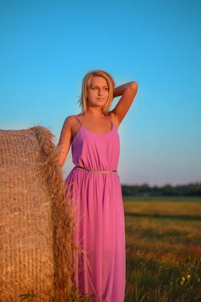 Happy woman with hay in meadow field — Stock Photo, Image