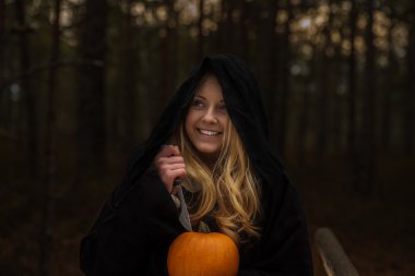 woman with pumpkin in forest clipart