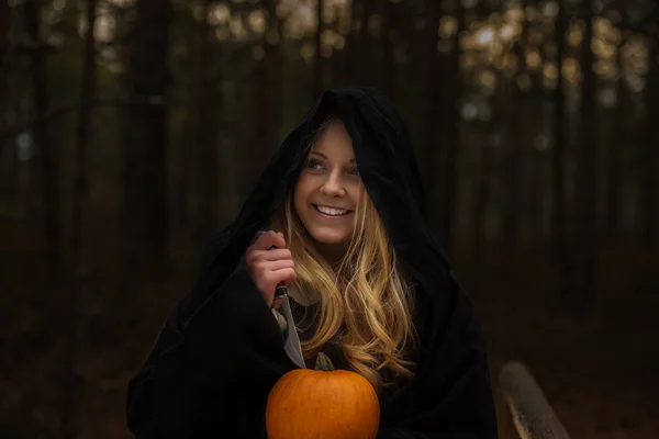 Woman with pumpkin in forest — Stock Photo, Image