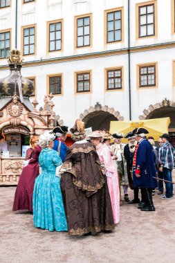 Courtyard of the castle, ladies and gentlemen in the costumes of clipart