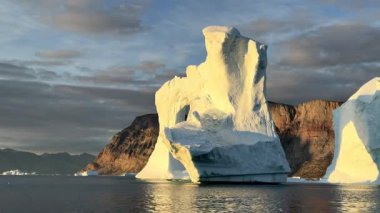 Nature is the best sculptor. Greenland, in Baffin Bay with ice floes, beautiful ice bridge, late afternoon. High quality movie