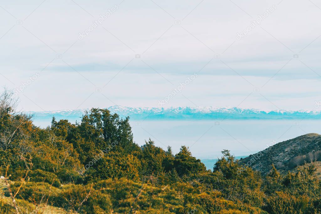 Landscape with views of a snowy mountain range in the distance