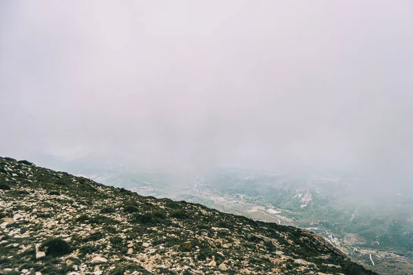 cloudy day with fog in the mountains of the natural park of the ports, in tarragona (spain). Photograph taken from a trail of the trekking path