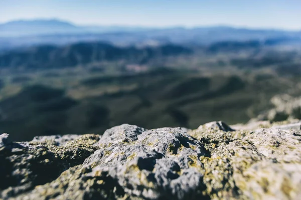 길들여진 돌들이 흩어져 산들의 지평선 가까이에서 보이는 — 스톡 사진