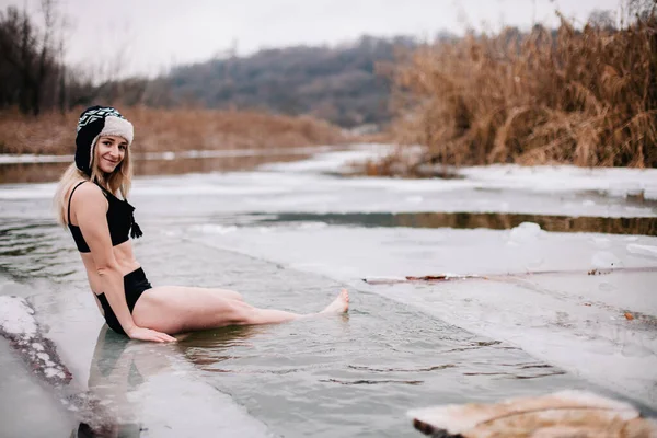 Young slender girl bathes in winter in a river hole — Stock Photo, Image