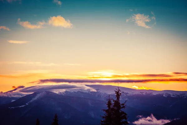 Beautiful dawn in the winter snow-covered mountains and amazingly beautiful clouds — Stock Photo, Image