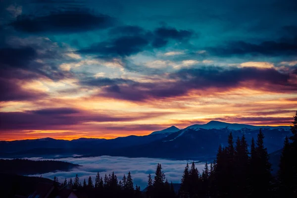 Beautiful dawn in the winter snow-covered mountains