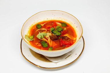 Beyaz arka planda, derin tabakta baharatlı çorba.