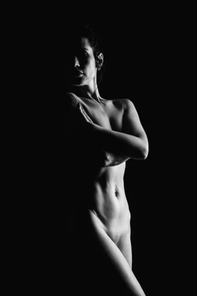 Silhouette of a young, slender, on a black background in a photo studio — ストック写真