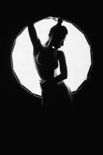 The silhouette of a young, slender, in the light of softbox. — 스톡 사진