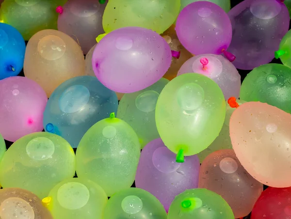 Colorful water-filled balloons prepared for summer camp play