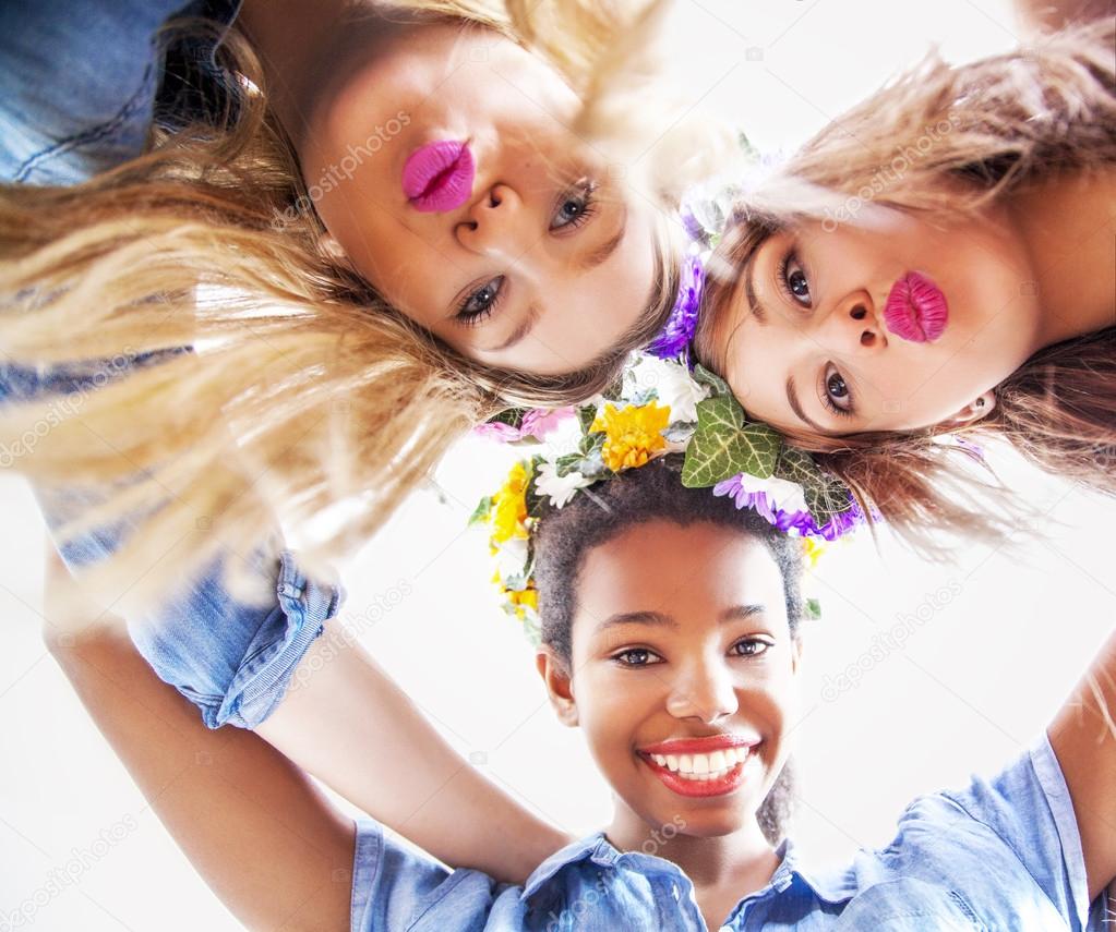 Cute teenage mixed race girls smiling, close - up.