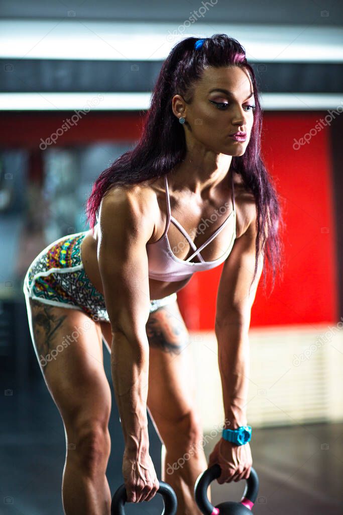 Body Building Workout.Fitness young woman exercising in gym, cross fit. 