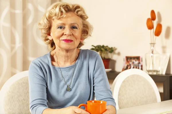 Blonde senior woman resting at home. — Stock Photo, Image