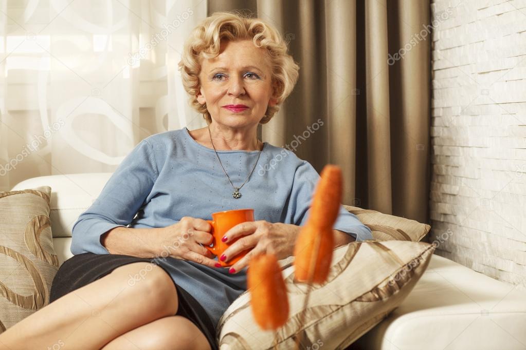 Blonde senior woman resting at home.