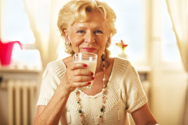 Elderly woman  having breakfast — Stock Photo, Image