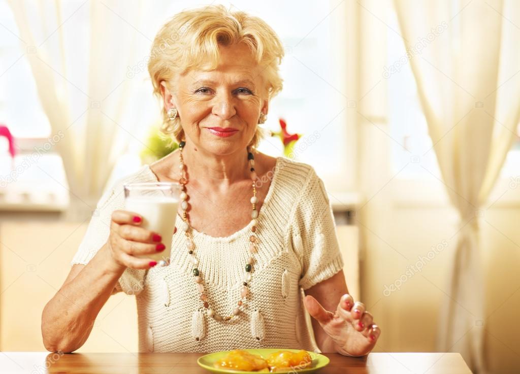 Elderly woman  having breakfast