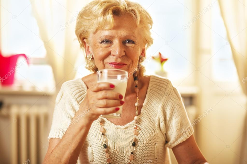 Elderly woman  having breakfast